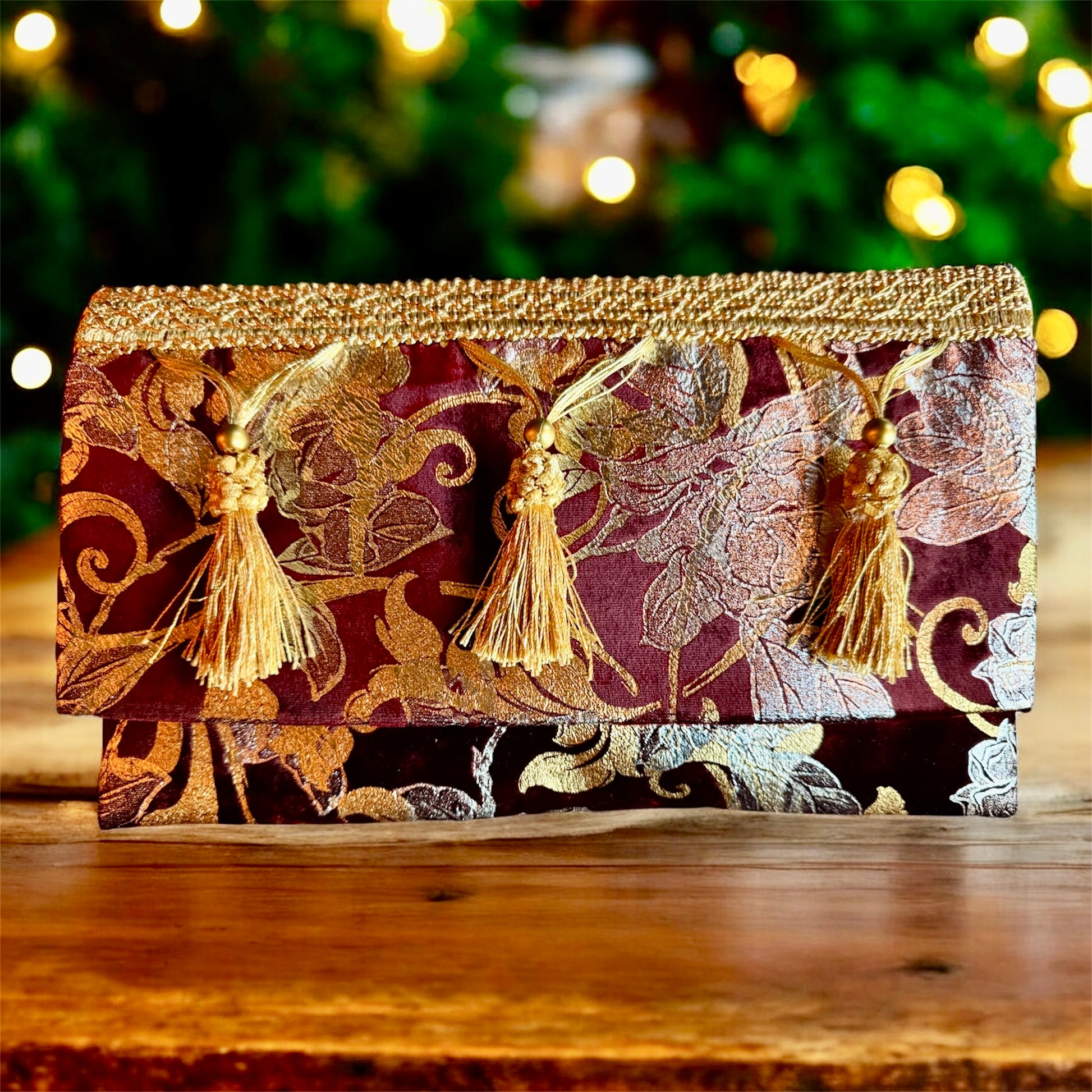 Dettaglio pochette couture Gianluca Lo Paro con nappe dorate e ricami oro e argento
